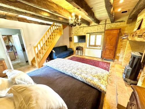 a bedroom with a large bed and a staircase at The Lion House in Mouzens