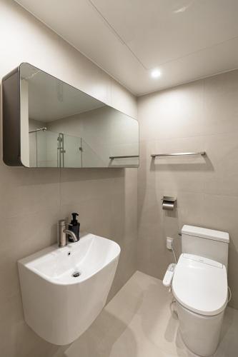 a white bathroom with a sink and a toilet at Hotel Modak Namdaemun in Seoul