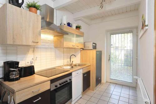 a kitchen with a sink and a counter top at Haushaelfte-Hein-105 in Böhl