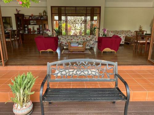 a bench in a living room with red chairs at Exclusive 10-Person Villa with Pool & land 6000m in Ban Hui Yai Muk
