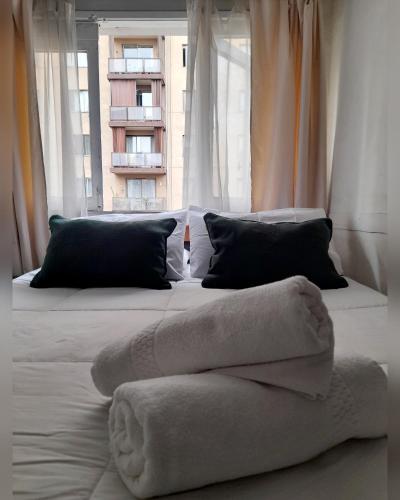 a bedroom with a bed with a towel on it at Atacama Hostel Backpackers in Santiago
