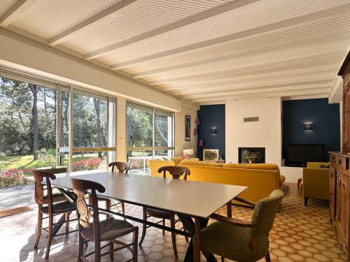 un salon avec une table et des chaises dans l'établissement Villa lumineuse 3 chambres avec jardin à La Palmyre - FR-1-705-104, aux Mathes