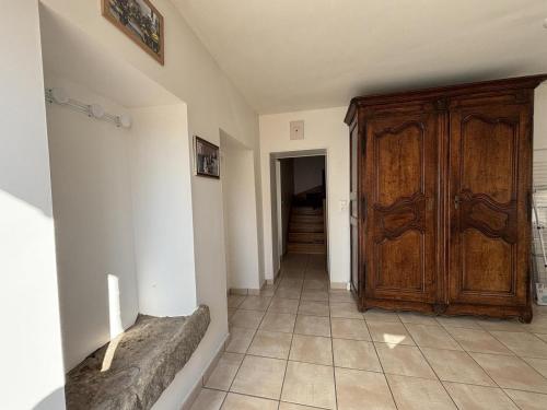 a hallway with a large wooden door in a room at Gîte chaleureux avec jardin clos en Auvergne - FR-1-489-573 in Saint-Bonnet-de-Rochefort