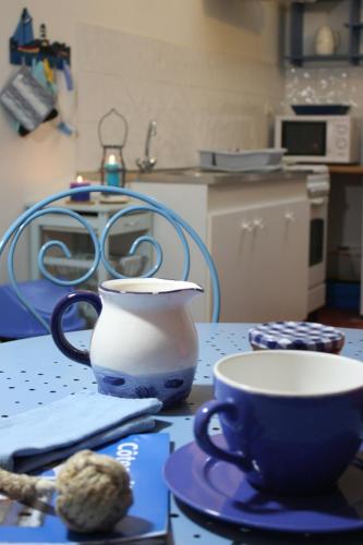 a table with a vase and a cup on it at Les Keriaden's in Pleudihen