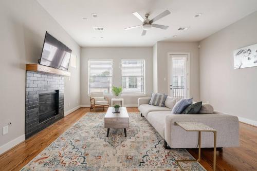 a living room with a couch and a fireplace at Private, city view , 5 beds, 2 balconies, Jacuzzi in Houston
