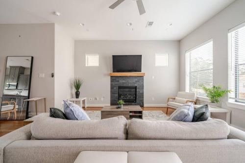 a living room with a couch and a fireplace at Private, city view , 5 beds, 2 balconies, Jacuzzi in Houston