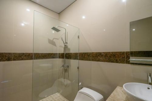 a bathroom with a shower and a toilet and a sink at Villa Latsu Canggu in Canggu