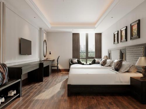 a bedroom with a bed and a desk and a piano at MT Collection Hotel Ha Long in Ha Long