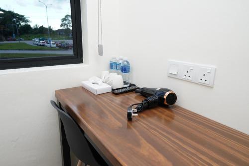 a desk with a phone on top of it at Anta Hotel in Johor Bahru