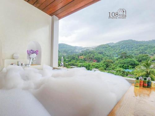 a bedroom with a view of a mountain at 108 Villa @ PongYang in Chiang Mai