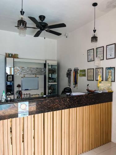 a kitchen with a bar with a ceiling fan at Seaview Mansion Dalaguete Apartment 3 in Dalaguete