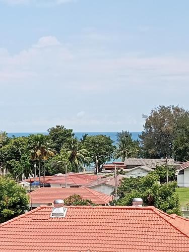 a group of roofs with trees in the background at Couple place in Port Dickson