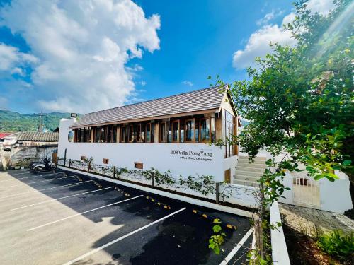 a white building with windows on the side of it at 108 Villa @ PongYang in Chiang Mai