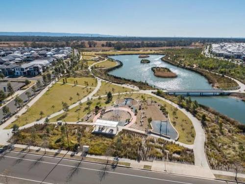 an aerial view of a park next to a river at Luxury Newly Built Home Queen Room in Marsden Park