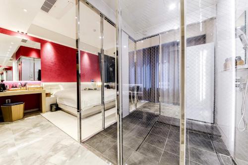 a master bedroom with a red accent wall at Hotel OSCAR in Daegu