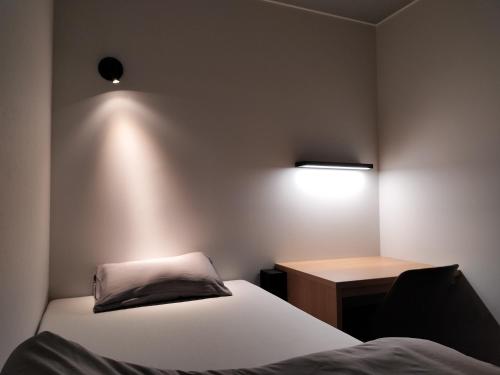 a small room with two beds and a desk at LEU Guest House in Nasushiobara