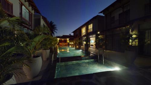 a courtyard of a building at night with plants at Paradise in the Heart of Mauritius in Grand Baie
