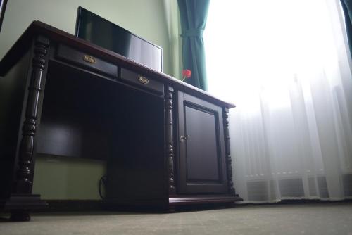 a black cabinet with a television on top of it at Grand Central in Carei