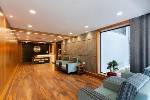 a waiting room with couches and a large window at Hotel Orchid Suites Kokapet, Business Hotel in Hyderabad