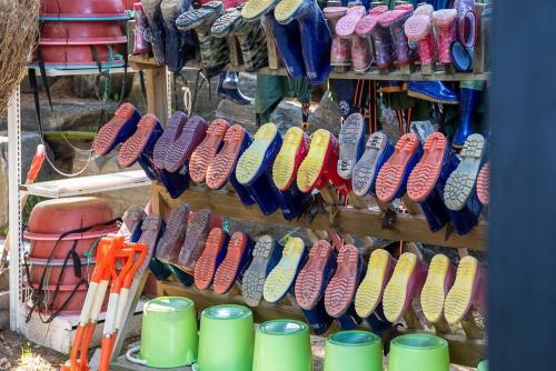 a bunch of shoes are lined up on a rack at Taean Red Balloon Pension in Tangam-ni