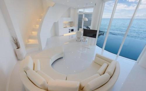 a white room with a table and chairs on a yacht at Pohang Escape Ocean View Pool Villa in Hajŏng-ni