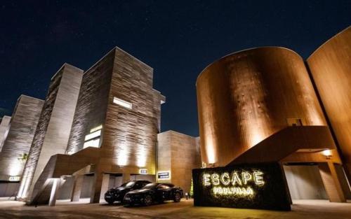 a large building with cars parked in front of it at Pohang Escape Ocean View Pool Villa in Hajŏng-ni