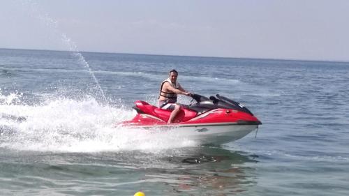 a man on a jet ski in the water at Diana's Penthouse in Perea