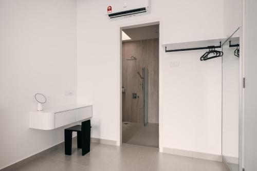 a bathroom with a white sink and a shower at Romantic Rooftop Jacuzzi Villa with Sunset Views in Jelutong