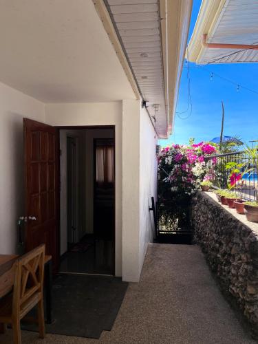 a hallway of a house with a door and flowers at Seaview Mansion Dalaguete Apartment 3 in Dalaguete