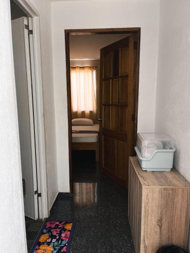 a room with a bathroom with a sink and a door at Seaview Mansion Dalaguete Apartment 3 in Dalaguete