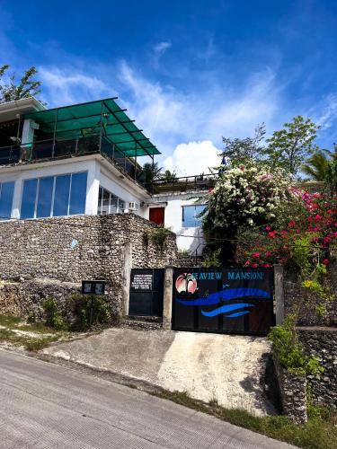 a building with a sign in front of it at Seaview Mansion Dalaguete Apartment 3 in Dalaguete