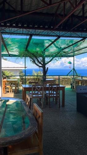 a group of tables and chairs under a tent at Seaview Mansion Dalaguete Apartment 3 in Dalaguete