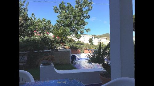 a balcony with a view of a garden and a pool at Casa Acqua Marina Ponza in Ponza