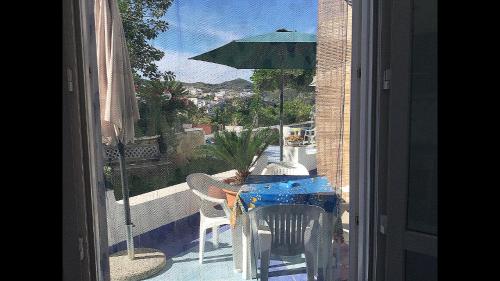 a view of a balcony with a table and an umbrella at Casa Acqua Marina Ponza in Ponza