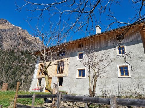a building with a fence in front of it at Laimbruchhof Apartments Urlaub auf dem Bauernhof in Val di Vizze