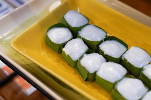 a yellow plate with green and white marshmallows at Thanicha Resort Amphawa in Amphawa