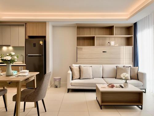 a living room with a couch and a table at Circle 31 #1BR Bangkok in Bangkok