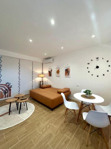 a bedroom with a bed and a table and chairs at Villa Abba in Durrës