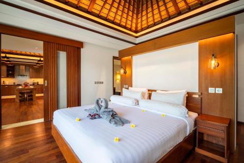 a bedroom with a bed with a towel on it at Bali - Jimbaran Beach Villa Private Pool in Jimbaran