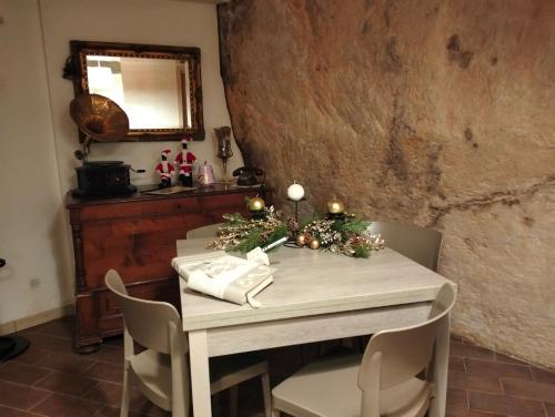 a dining room table with a christmas tree on it at Sassi Sotto Le Stelle in Matera