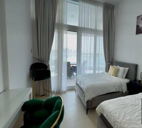 a hotel room with two beds and a window at Fleur Star Apartments in Dubai