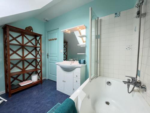 a bathroom with a tub and a sink and a shower at Villa Isaac - Piscine naturelle - Proche Boulerie Jump - 8p in Le Mans