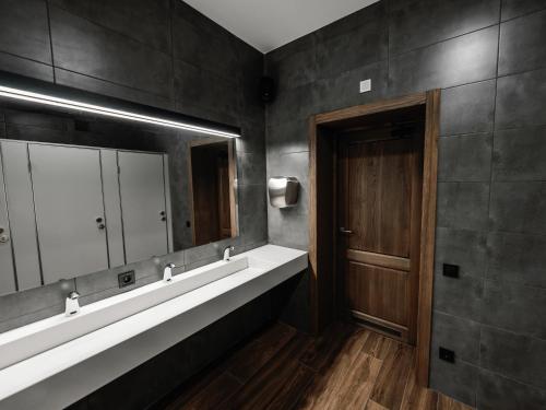 a bathroom with a sink and a mirror at Nesvit Hotel in Kyiv