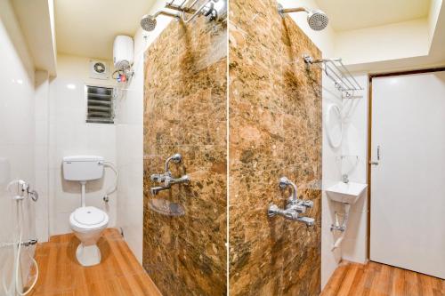a bathroom with a shower and a toilet at Super Townhouse Kaikhali Near Airport in Kolkata