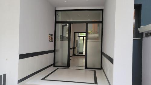 a hallway with glass doors in a building at Tedi's Nest in Vlorë
