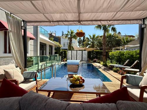 a patio with a table and a swimming pool at Villa Annabèll1 with Swimming pool and Jacuzzi, 3 floors in Belek