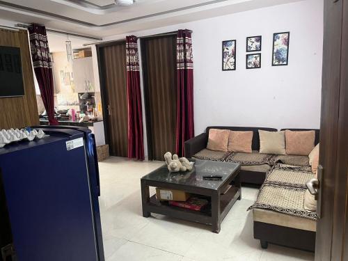 a living room with a couch and a table at Jiya-Vira Home in New Delhi