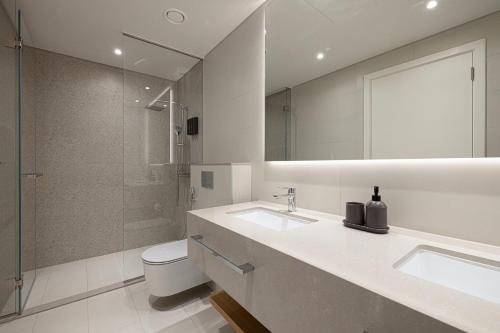 a bathroom with a toilet and a sink and a shower at La Vie, JBR private beach, private parking and pool in Dubai