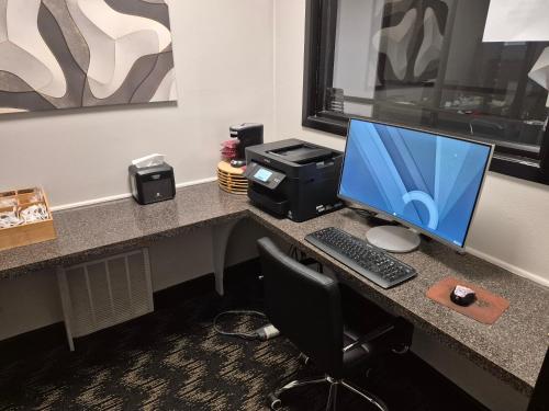 a desk with a computer monitor and a printer at Abilene Whitten Inn in Abilene