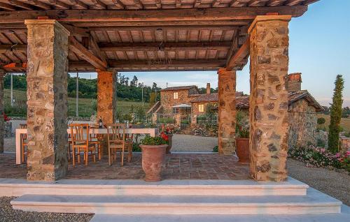a wooden pergola with a table and chairs on a patio at Cozy Home In Trevinano in Trevinano